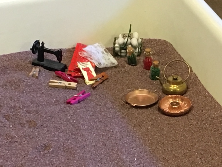 A group of objects on a carpet  Description automatically generated